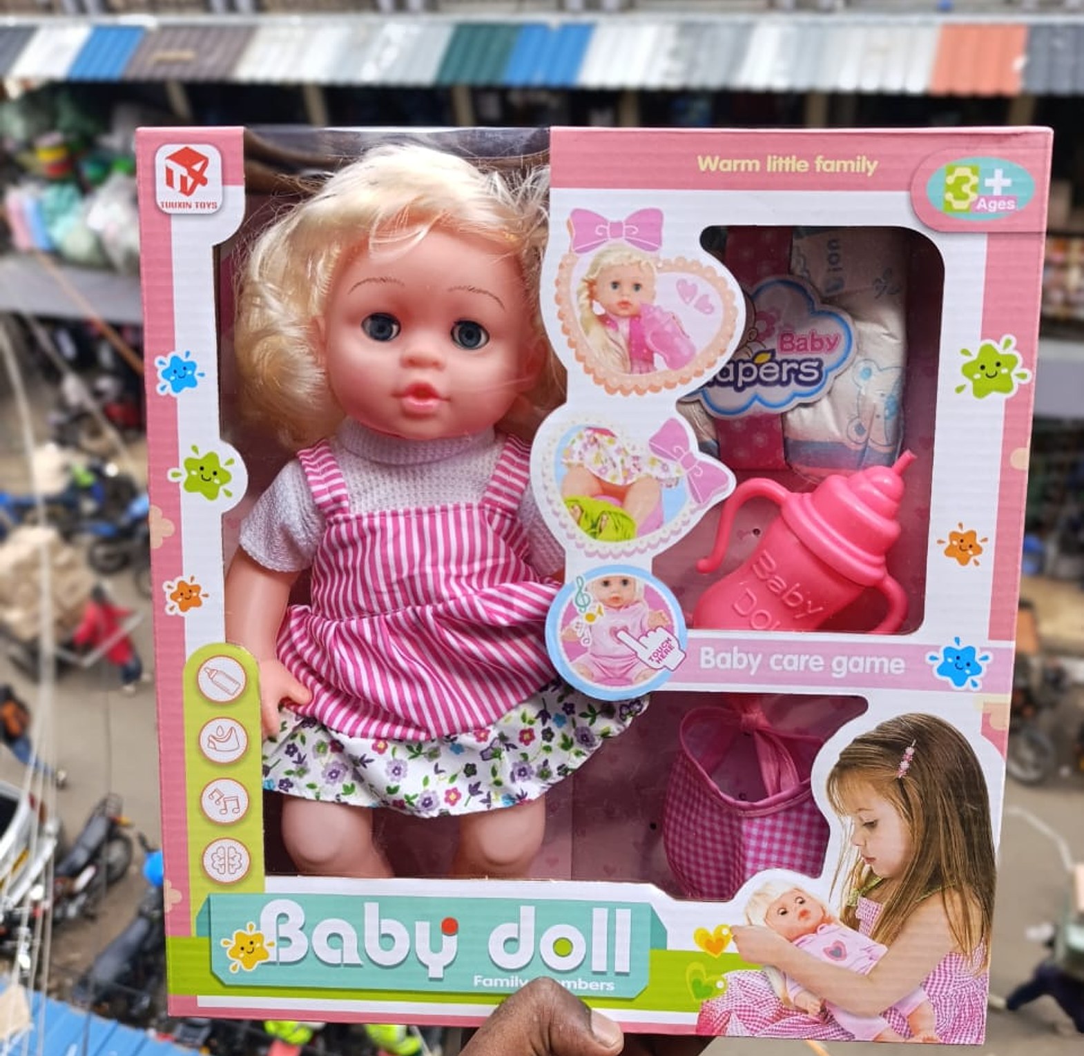 Doll. White baby doll with a care kit(feeding bottle and diapers) image