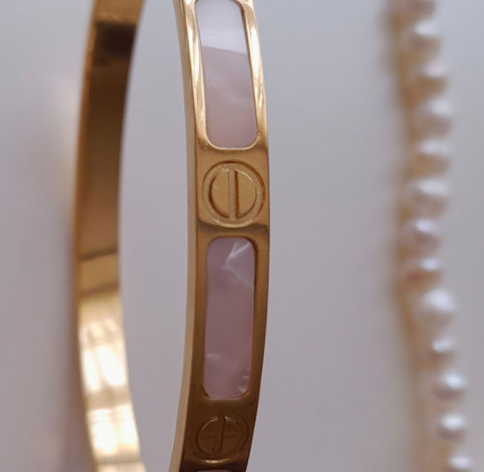 Gold love bracelet with a marble touch image