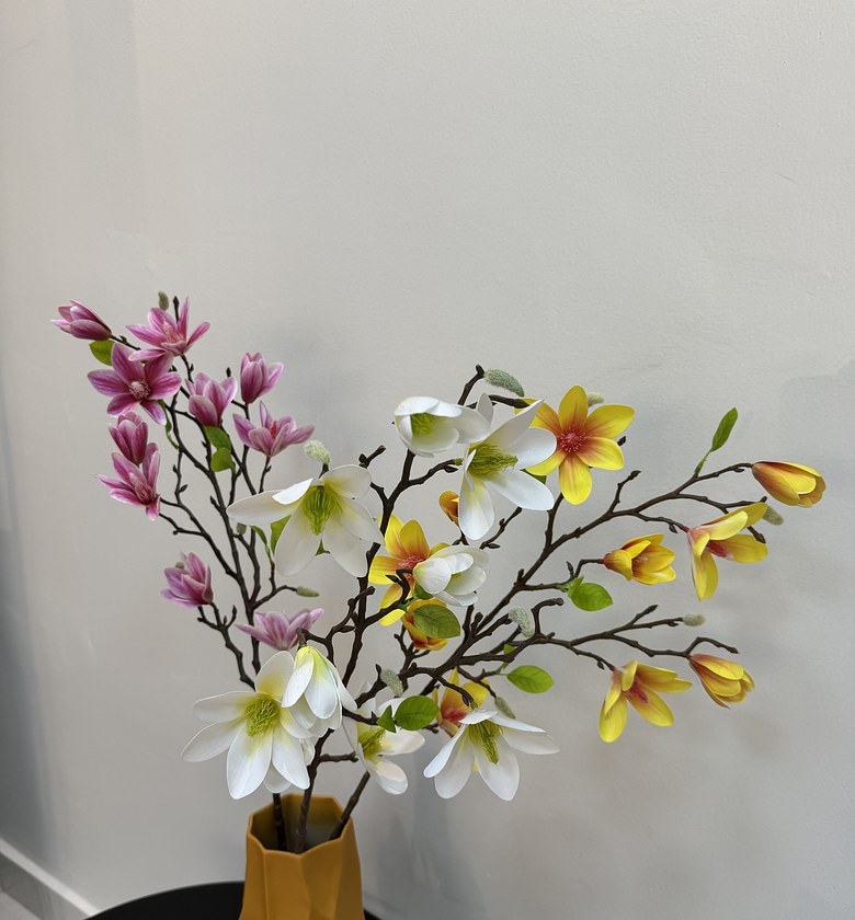Faux blooming magnolia branches. image