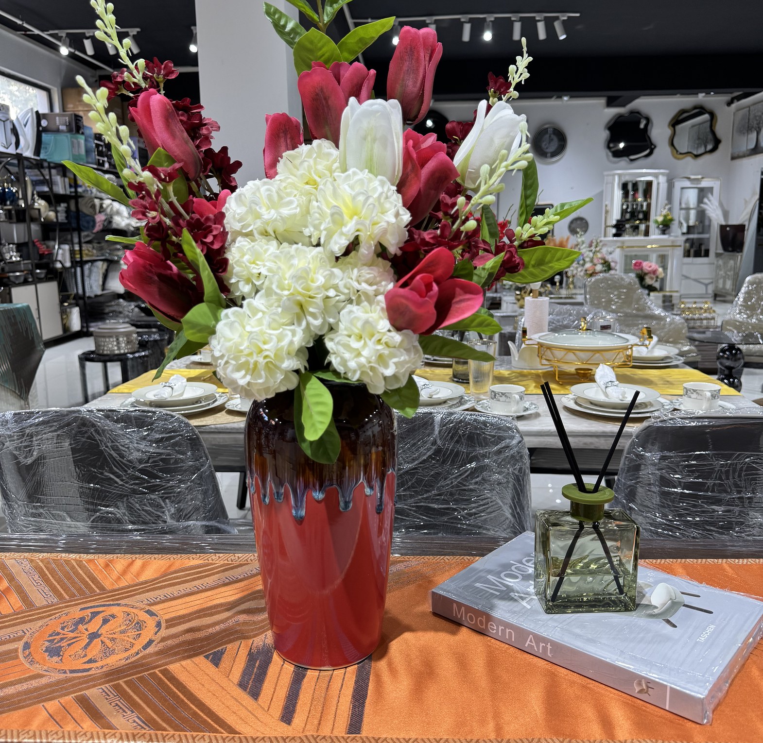 Tulips paired with hydrangeas in a red vase image