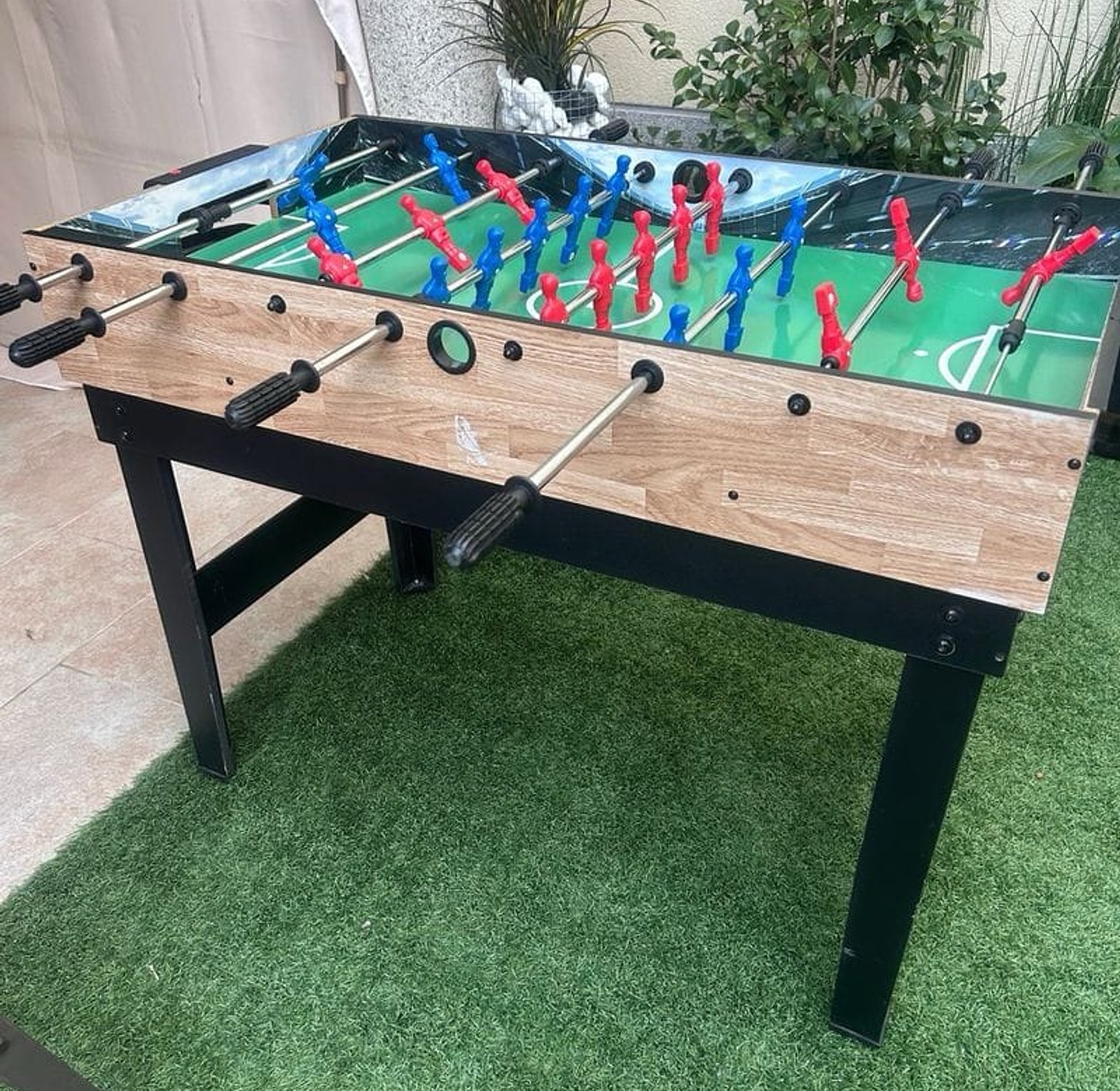  Foosball Table Game. Players use rods with attached figures to strike the ball into the opposing goal. image